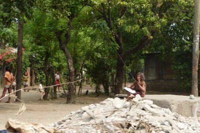 As we went by, I saw one of the kid's sitting on a rock colouring