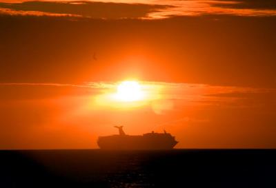 Carnival ship sailing in sunset off Grand Turk