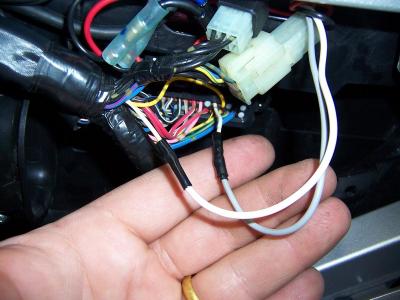 The white wire from the Yellow box goes to the harness side of the cut wire, and the gray wire goes to the connector side