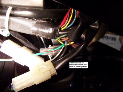 Brake wire gets connected to green wire with red strip on cancel unit