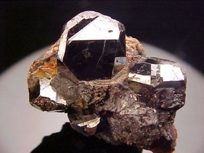 Mirror-bright 2 cm twinned rutile crystal on 43 mm matrix. Graves Mountain, Georgia, USA.