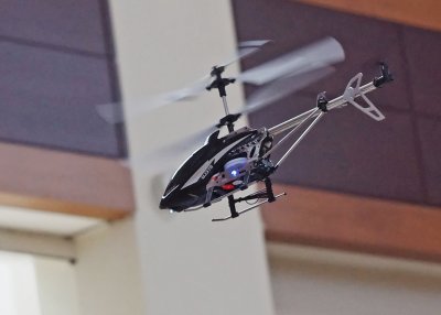 A RADIO CONTROLLED TOY HELICOPTER BEING DEMONSTRATED IN A CHARLOTTE, NORTH CAROLINA SHOPPING CENTER