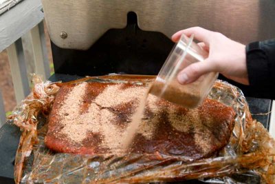 Final dose of rub before entering the smoker