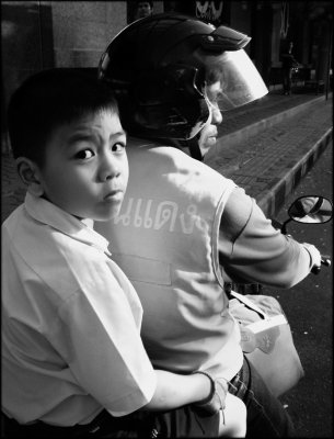 Schoolboy on motorbike taxi.jpg