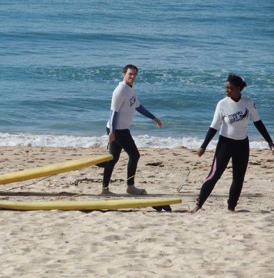 Grant dragging a surfboard