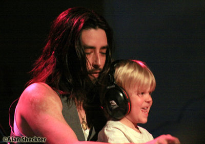 Jackie Greene brings 5-year-old local boy Quinn up onto the piano bench