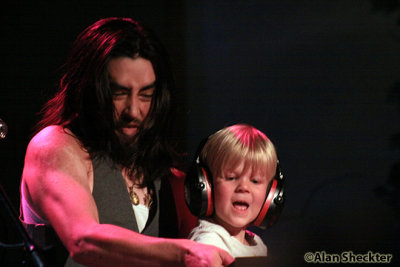 Jackie Greene brings 5-year-old local boy Quinn up onto the piano bench