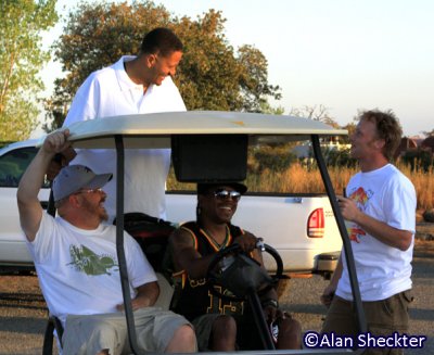 Chali 2Na gets a ride from his keyboardist; also in photo are festival co-directors Bob Backstrom (left), Steve Swim (right)