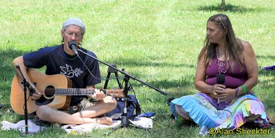 John-Michael Sun and Susan Dobra leading kirtan session on the Evergreen lawn