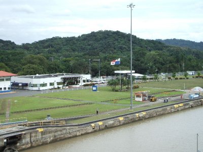 Panama Canal -Pedro Miguel Locks. Panama flag waving proudly