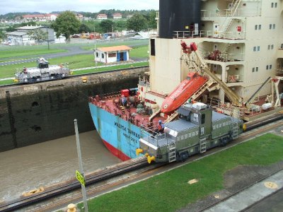 Panama Canal -Miraflores Locks, showing how mules w/ cables keep ships direct center of the canal