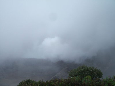 Puentarenas, Costa Rica -looking down thru clouds at Poas crater w/ plume coming up