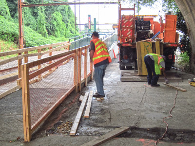 Removing the temporary railing on the ramp and the wooden track crossing