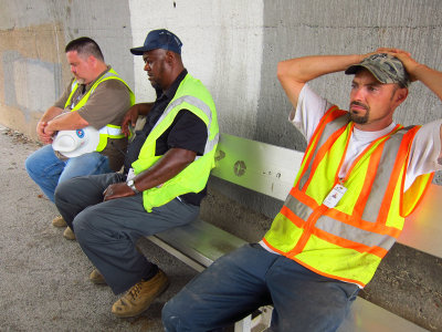 Workmen nap or rest after 13 hours on the job