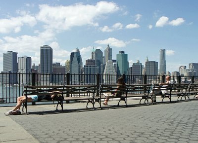 Against a Manhattan skyline, a Brooklyn jogger takes a rest