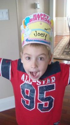 home from school with his birthday hat