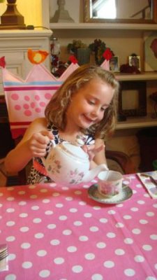 so excited to pour herself pink lemonade out of a real china tea pot