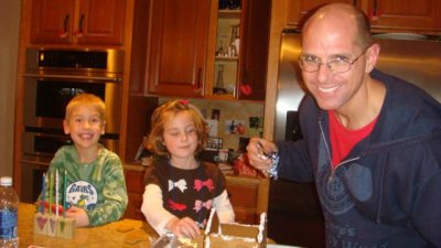 daddy assembles the gingerbread house