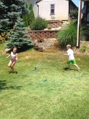 playing in the sprinkler is a great way to stay cool!