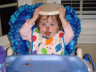 baby girl eats mommy's birthday cake