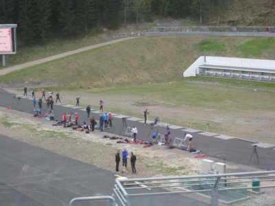 Locals training for biathlon on wheeled skis & target shooting.