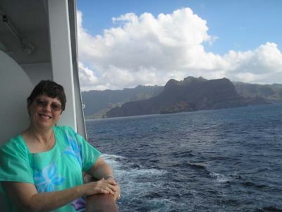 Patti on balcony approaching Nuku Hiva, in the Marquesas Islands