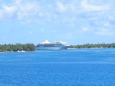 A ship coming through the break in the atoll