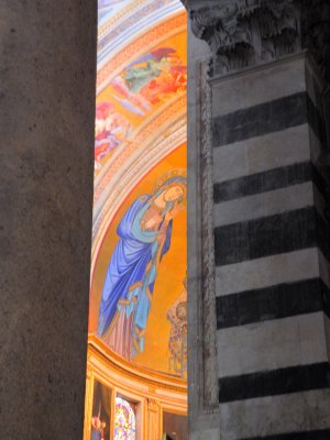 A glimpse of a fresco through the columns 