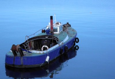 Old blue boat on the blue sea