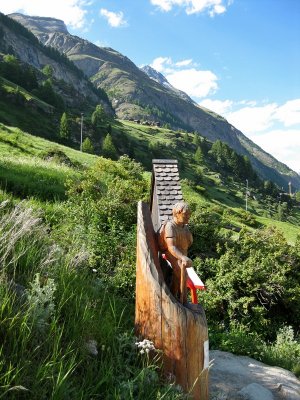 Zermatt.Wooden carved statue on the trail to Zmutt