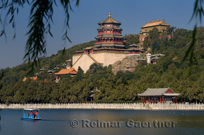 Paddle boaters on Kunming Lake with Buddhist Fragrance and Sea of Wisdom temples at Summer Palace Beijing