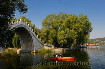 Couple rowing under the Jade Belt Bridge on Kunming Lake Summer Palace Beijing