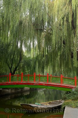 Old bridge and boat with willow trees in Changpu river park Beijing China