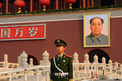 Peoples Armed Police officer with portrait of Mao Zedong at Tiananmen Gate of Heavenly Peace Beijing
