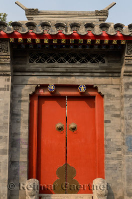 Red door and stonework at estate in Shichahai area hutong in Beijing China