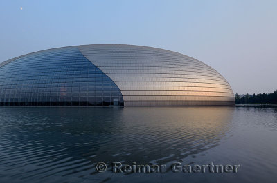National Centre for the Performing Arts at dusk with moon in Beijing China