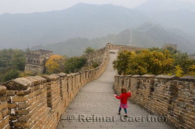 Little girl heading east with towers 11 and 10 on the Mutianyu Great Wall of China north of Beijing