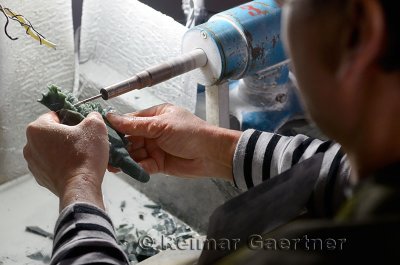 Craftsman carving jade stone with a water cooled diamond dremel in Beijing China