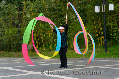 Ribbon streamer waving instructor at Zizhuyuan Purple Bamboo Park Beijing China