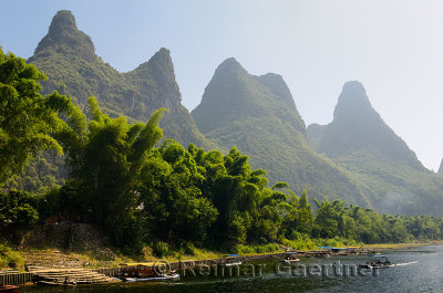 Steps to the Li river Guangxi China with fingerlike karst mountain peaks and bamboo
