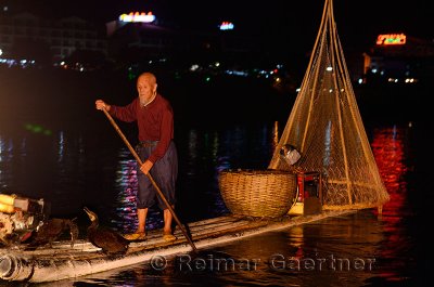 Chinese cormorant fisherman on the Lijiang river in Yangshuo China at night