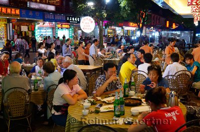 Eating alfresco at outdoor street restaurant at night in Yangshuo China