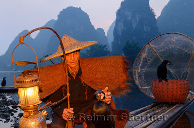 Chinese fisherman with cormorants at dawn on the Li river Yangshuo China