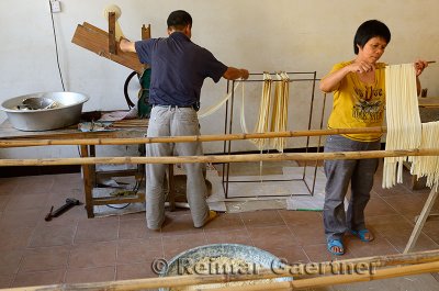 Noodle making husband and wife team in a shop in Fuli near Yangshuo China