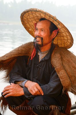 Close up of a smiling cormorant fisherman on the Li river at dawn Xingping China