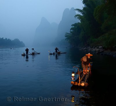 Early morning Cormorant fishermen on bamboo rafts on Li river near Xingping China