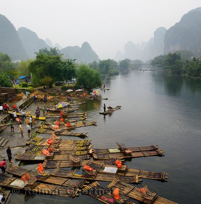 Stacking bamboo raft tour boats at Yangshuo for transport up the Yulong river China