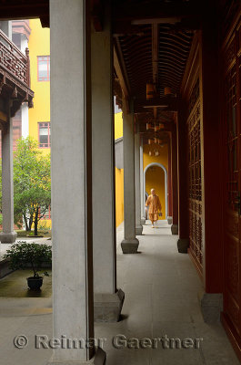 Resident Buddhist monk carrying steel bucket at the Ling Yin Temple in Hangzhou China