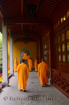 Buddhist monks in orange robes called to the dining hall of the Ling Yin Temple in Hangzhou China