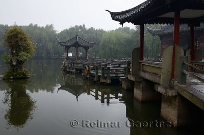 Gazebo walkway and stone pillar at Three Pools Mirroring the Moon Island in West lake Hangzhou China